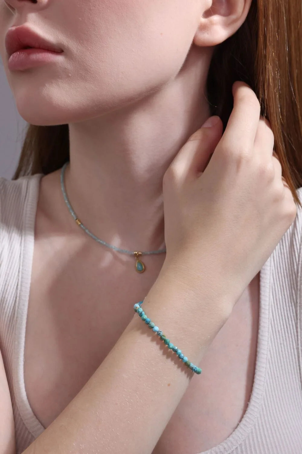 aquamarine beaded necklace layered with matching bracelet