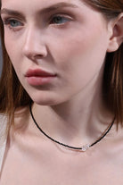 side view of black faceted beaded choker with crystal bow