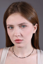 black seed bead choker with white heart beads – portrait view