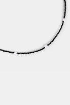 close-up of black faceted seed beads with white shell heart beads