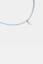 close-up of micro-faceted blue chalcedony beads with freshwater pearl charm