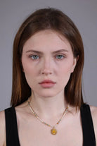 portrait of model with vintage boho sun pendant beaded necklace