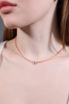 clear quartz charm on rose quartz beaded choker close-up