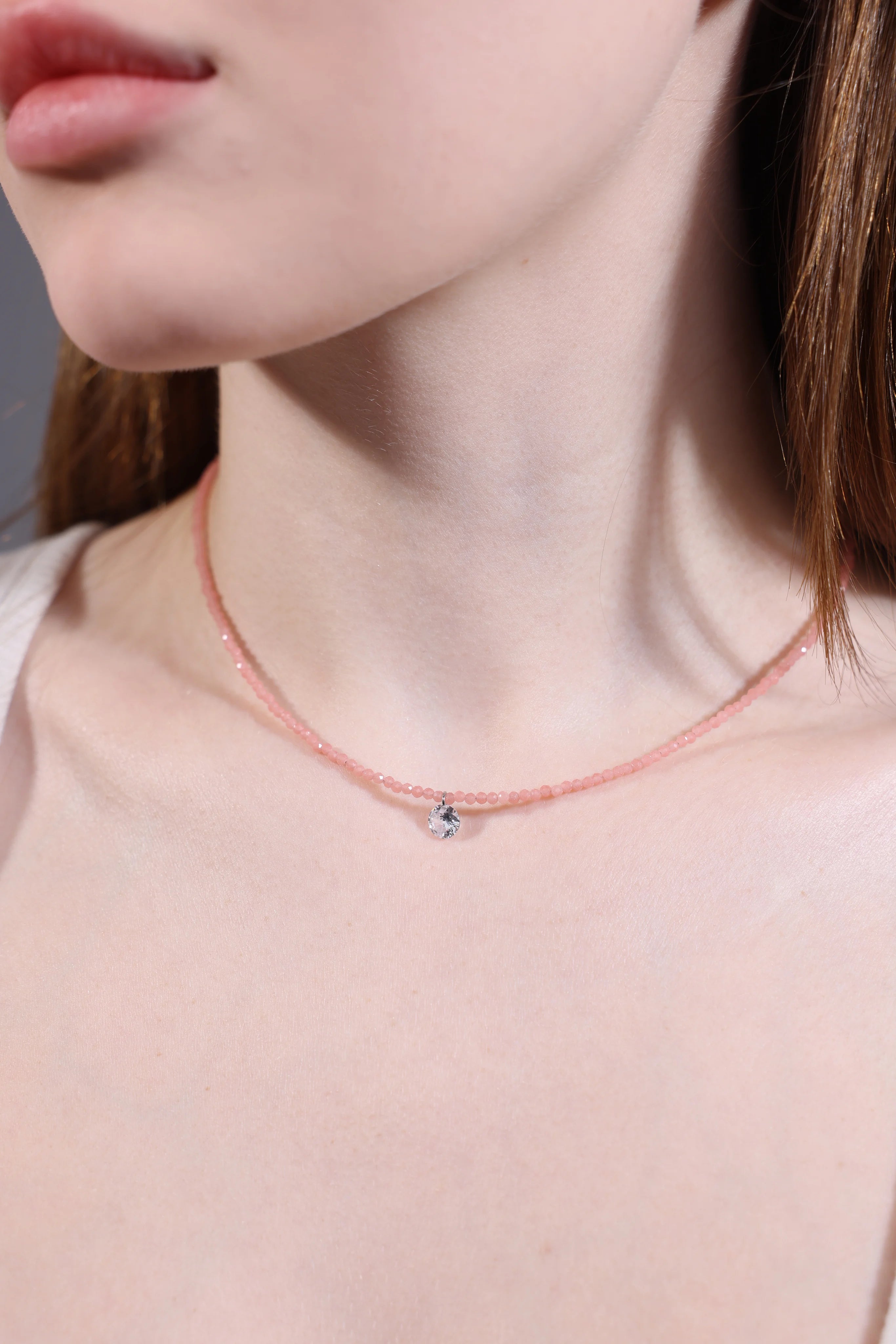 clear quartz charm on rose quartz beaded choker close-up