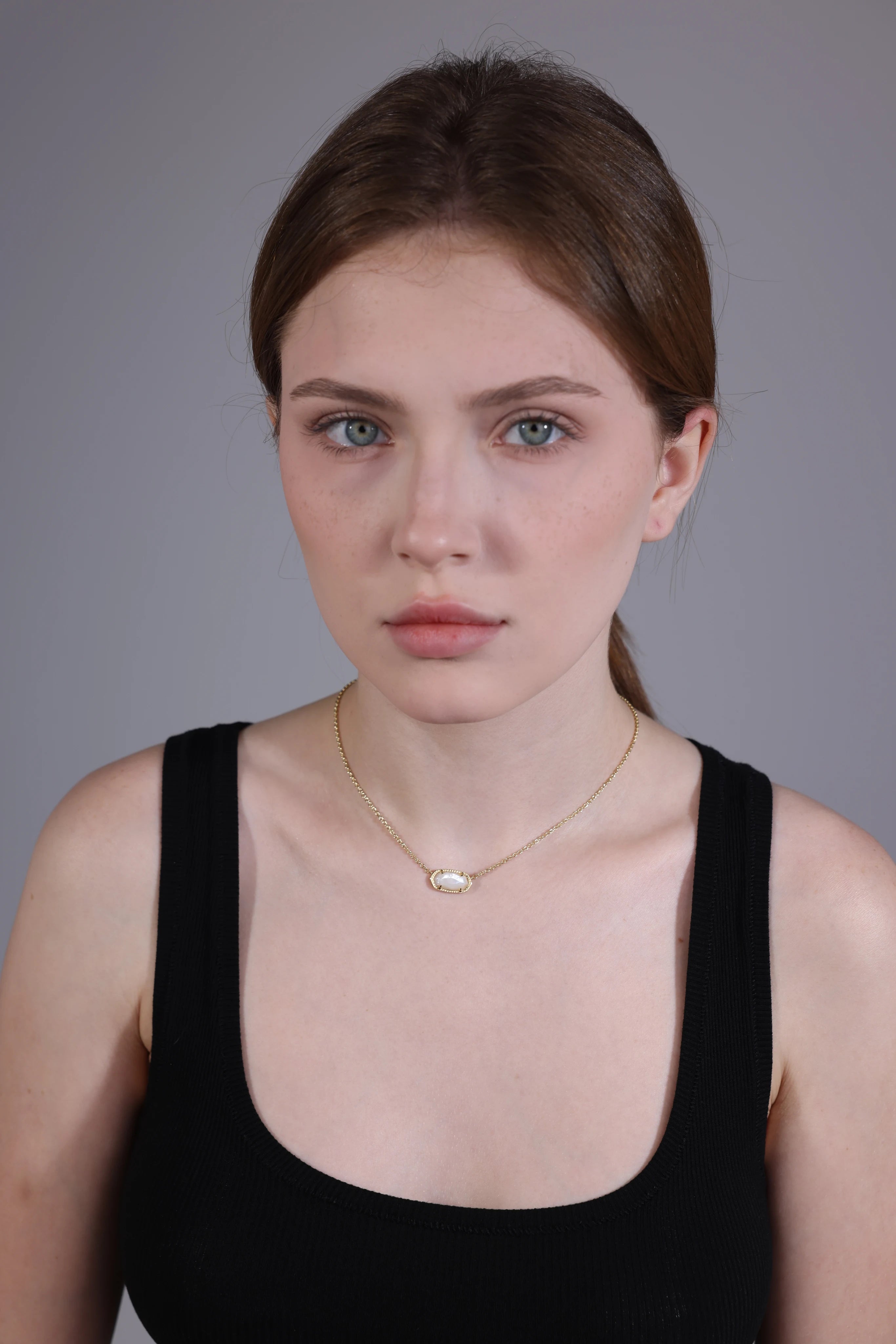 model wearing clear quartz pendant necklace – minimalist gold choker