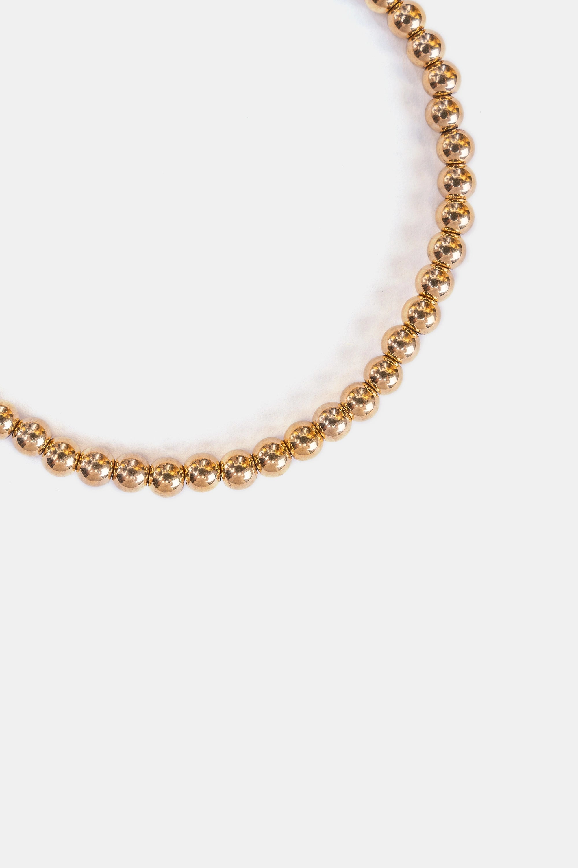 close-up of polished gold stainless steel beads – bracelet