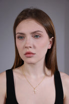 portrait of model wearing gold cross necklace – gift-ready minimalist jewelry