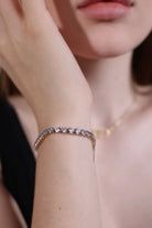 gold 4mm cubic zirconia tennis bracelet on wrist close-up