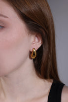 close-up of gold teardrop chunky dome hoop earring – Velvet Luminance
