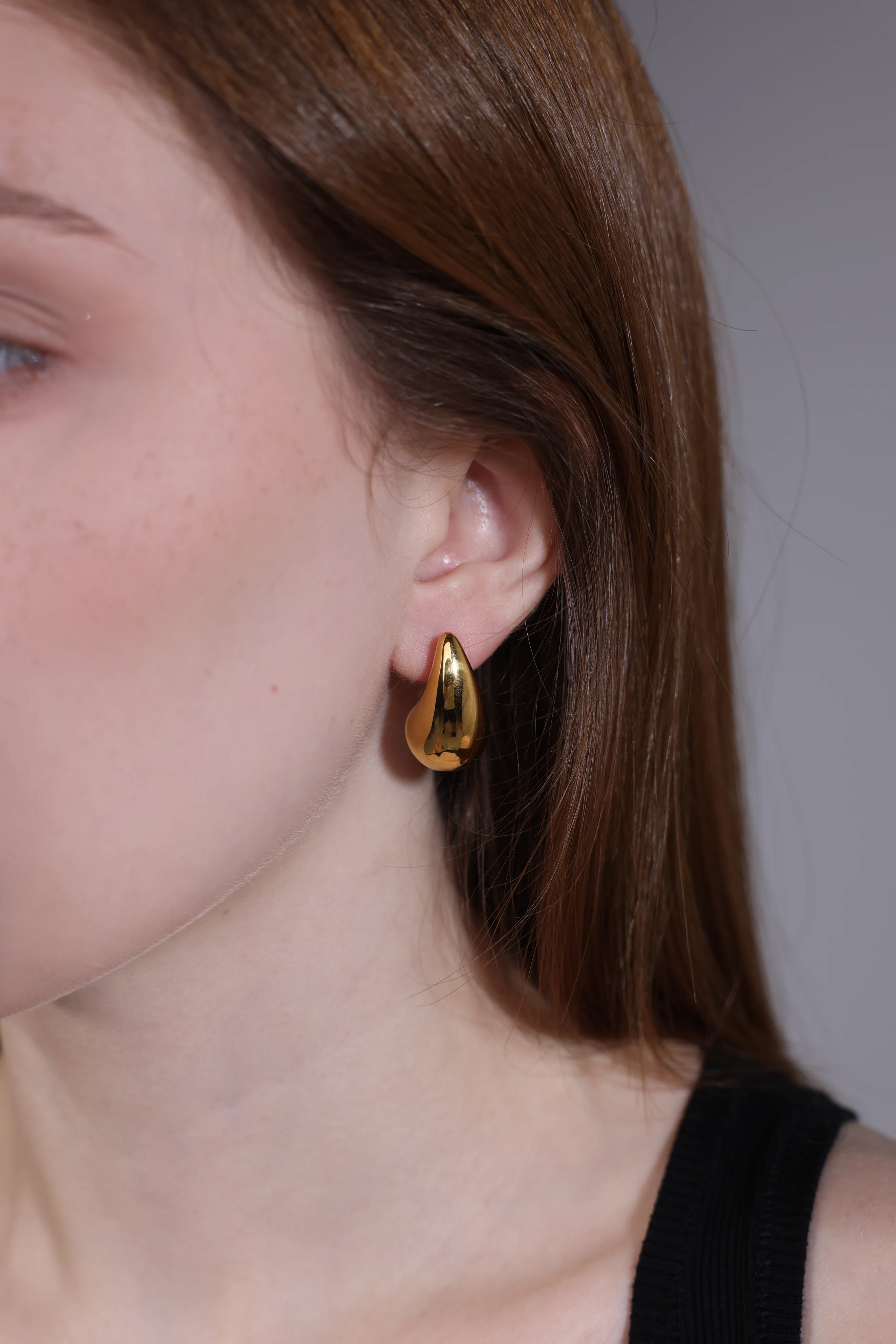 close-up of gold teardrop chunky dome hoop earring – Velvet Luminance