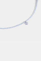 close-up of pale blue faceted seed beads with clear quartz charm