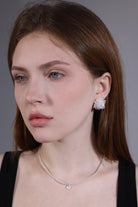 side view of pale blue faceted beaded necklace with quartz charm