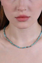 Close-up of turquoise beaded necklace showing natural matrix patterns