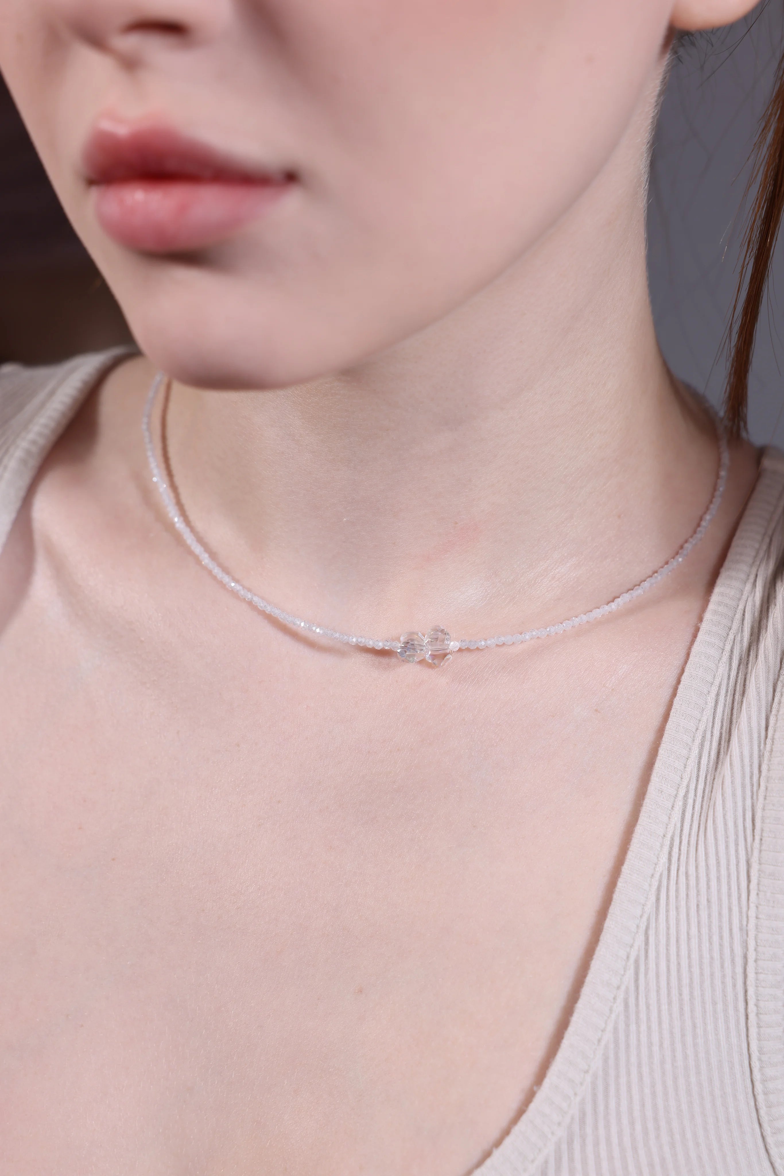 model wearing clear crystal bow beaded choker – minimalist layering