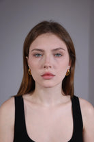 model wearing gold chunky teardrop earrings – bold retro statement jewelry