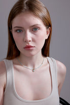 model wearing aquamarine beaded choker with teardrop pendant – minimalist jewelry