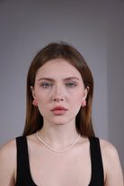 model wearing pink hydrangea beaded earrings – romantic floral jewelry