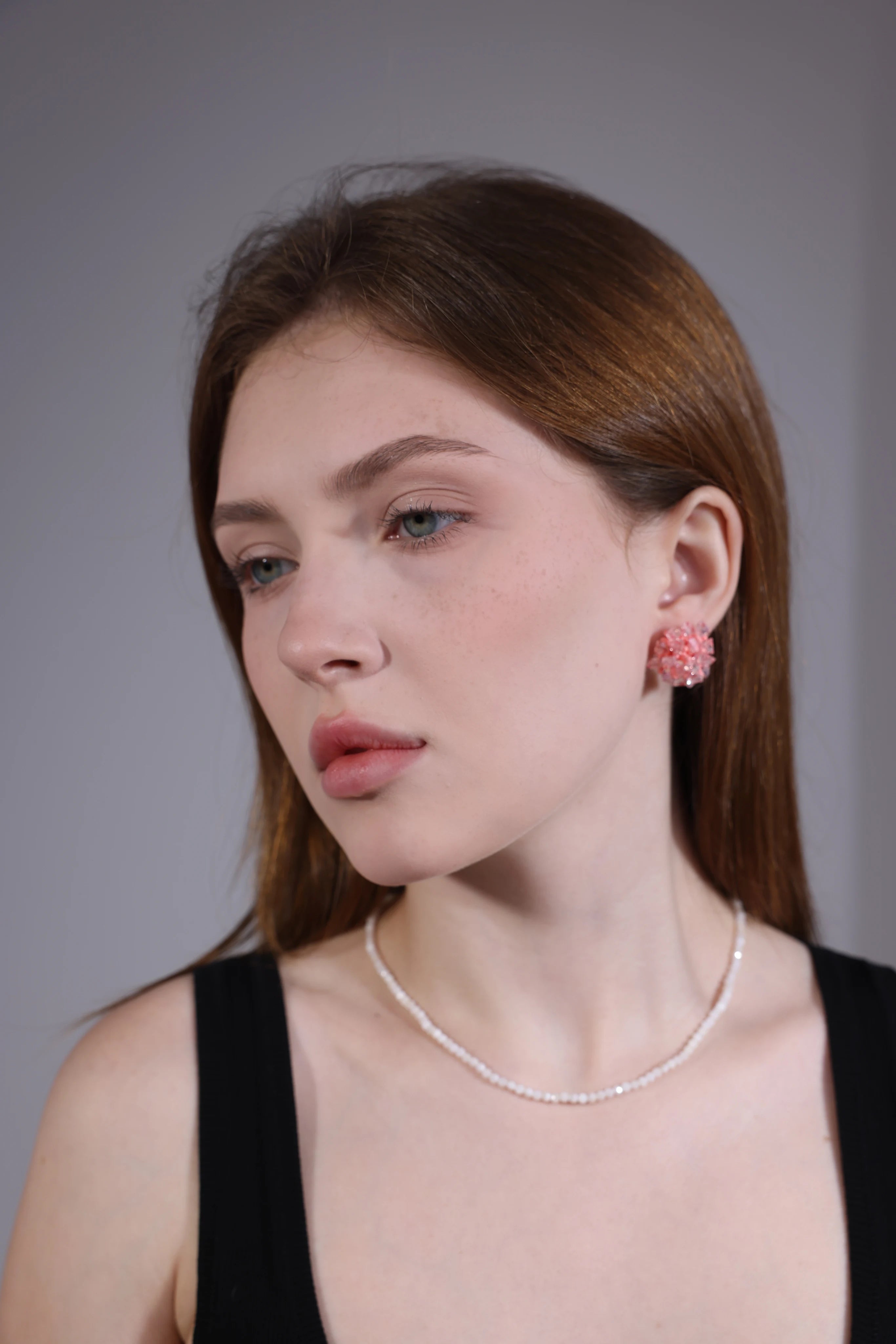 side view of model wearing pink beaded hydrangea cluster earrings