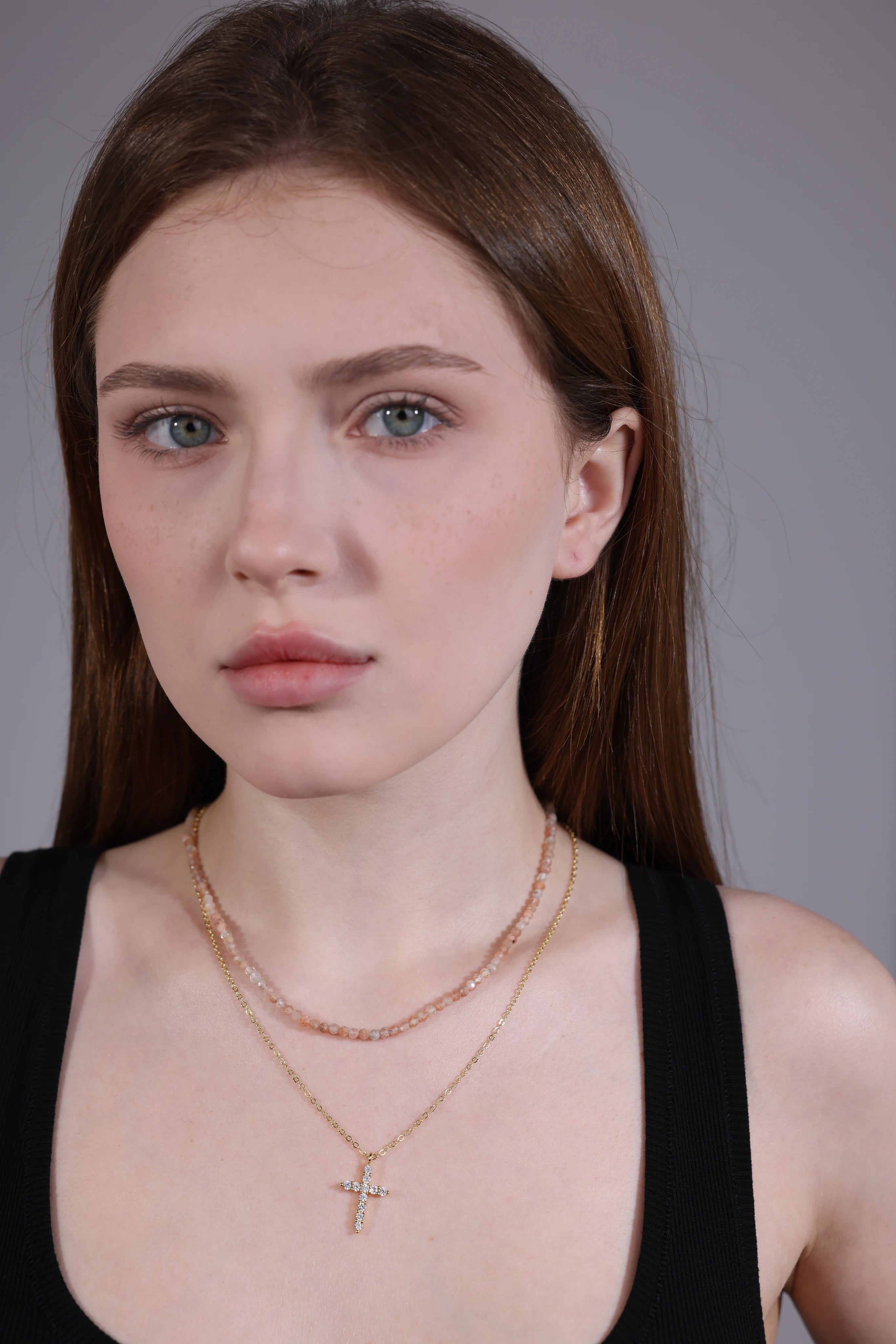 pink gemstone beaded necklace layered with gold chain