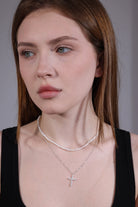portrait of silver cubic zirconia cross necklace on model
