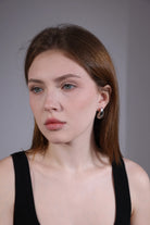 model wearing silver teardrop hoop earrings – minimalist retro jewelry