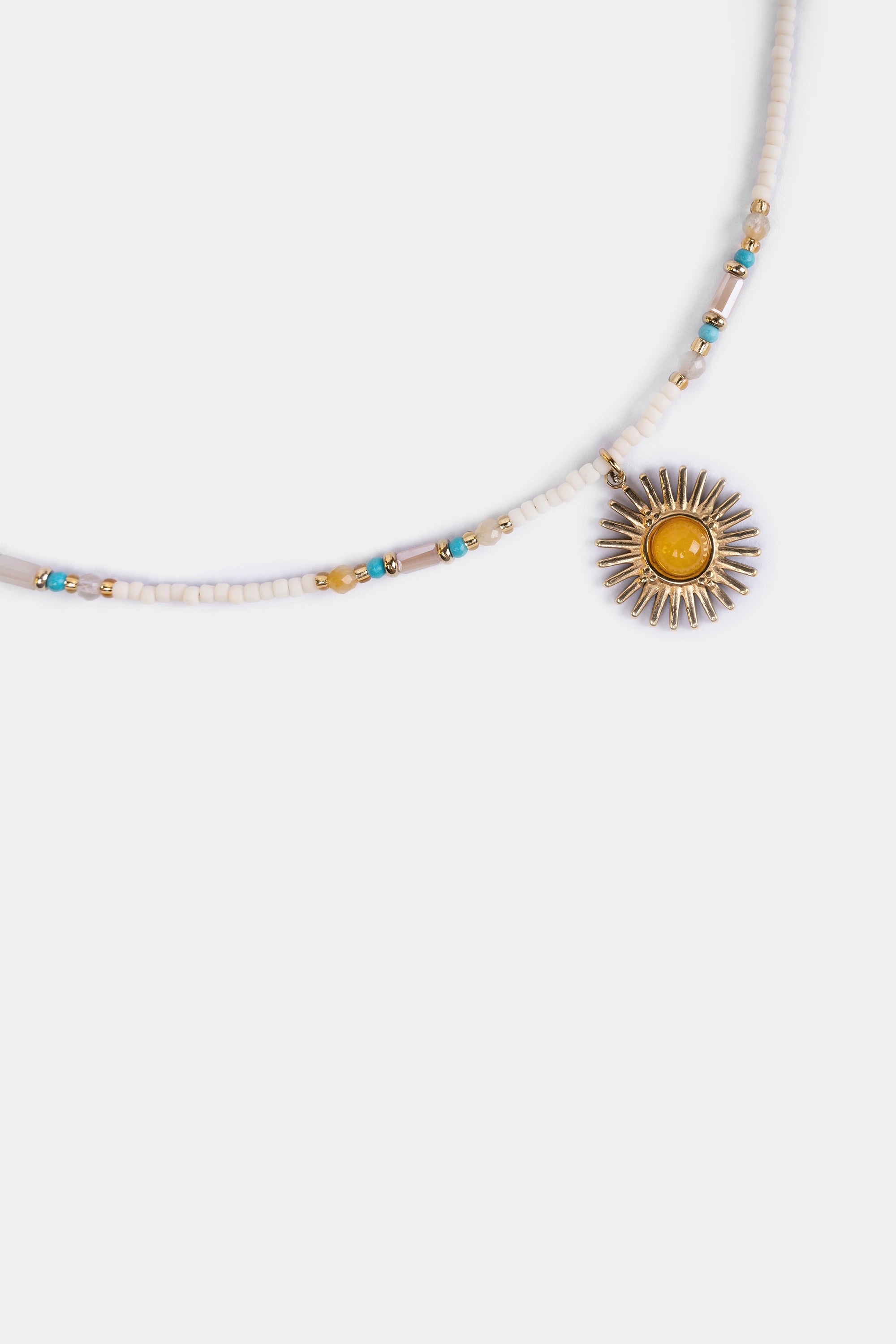 close-up of tribal beaded necklace with radiant sun pendant