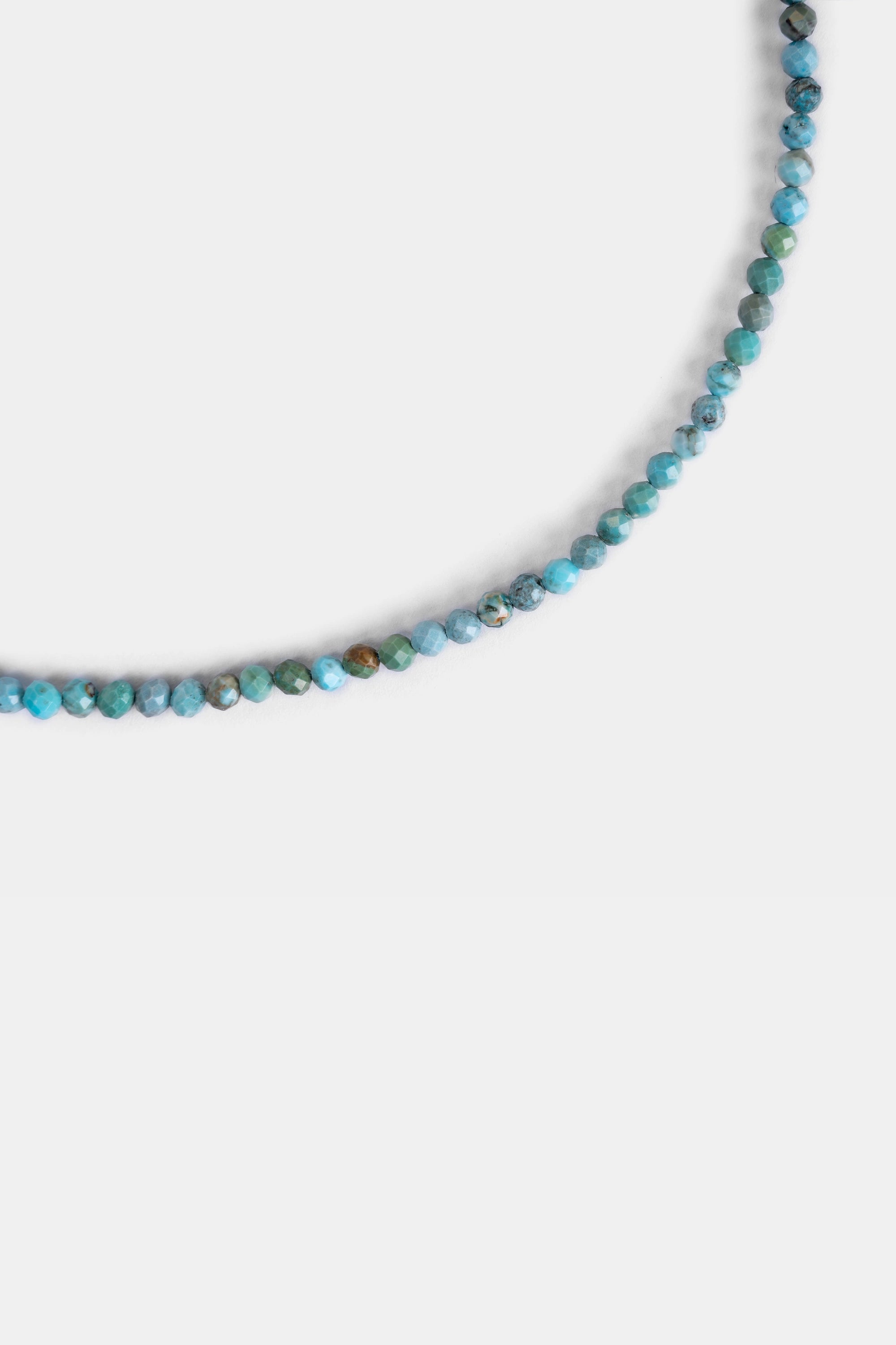 Close-up of 3.2mm faceted natural turquoise beads in blue-green tones