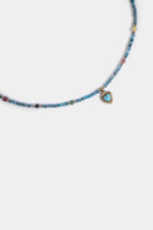 close-up of aqua seed beads with turquoise heart pendant