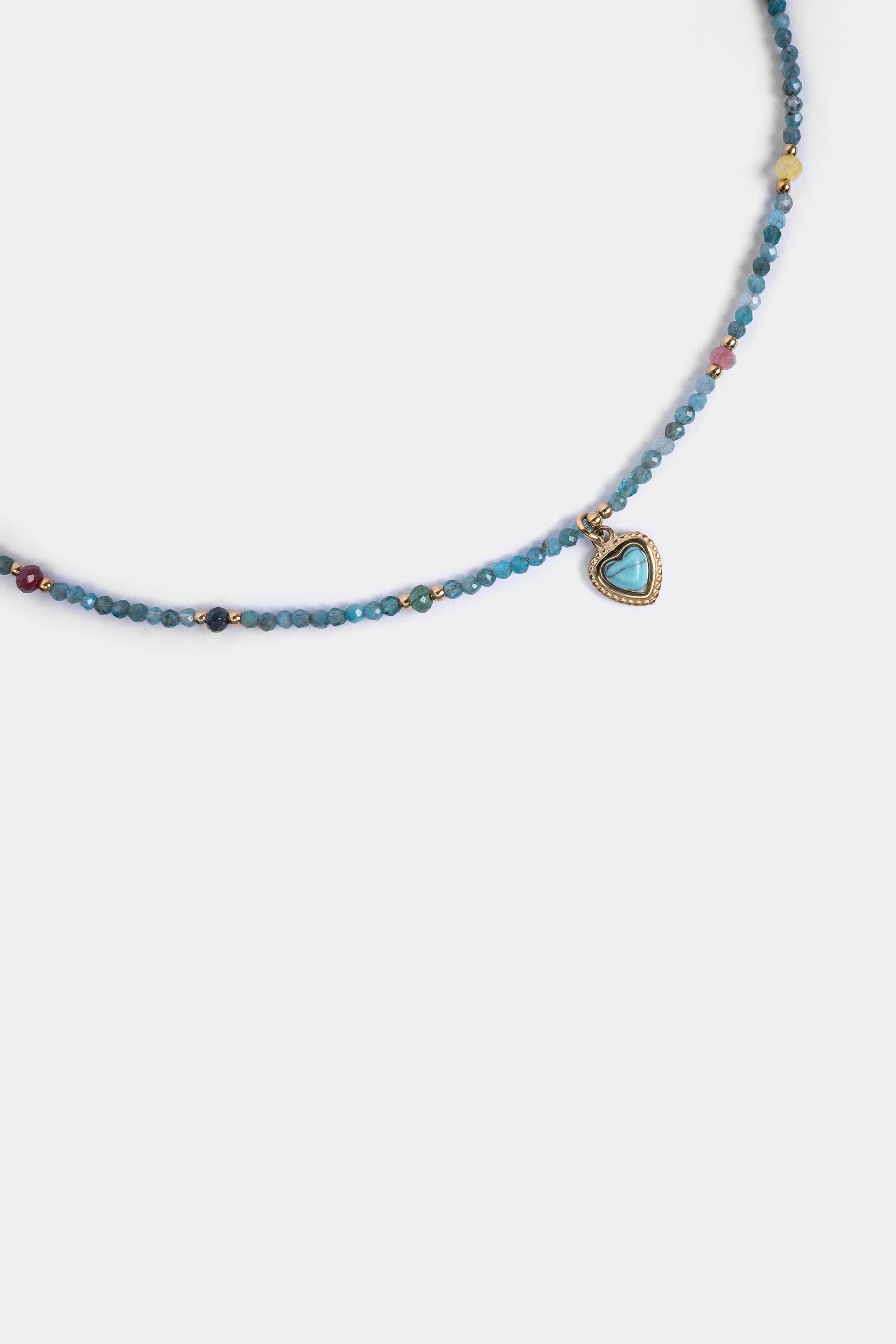 close-up of aqua seed beads with turquoise heart pendant