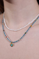side view of turquoise heart pendant choker with aqua seed beads