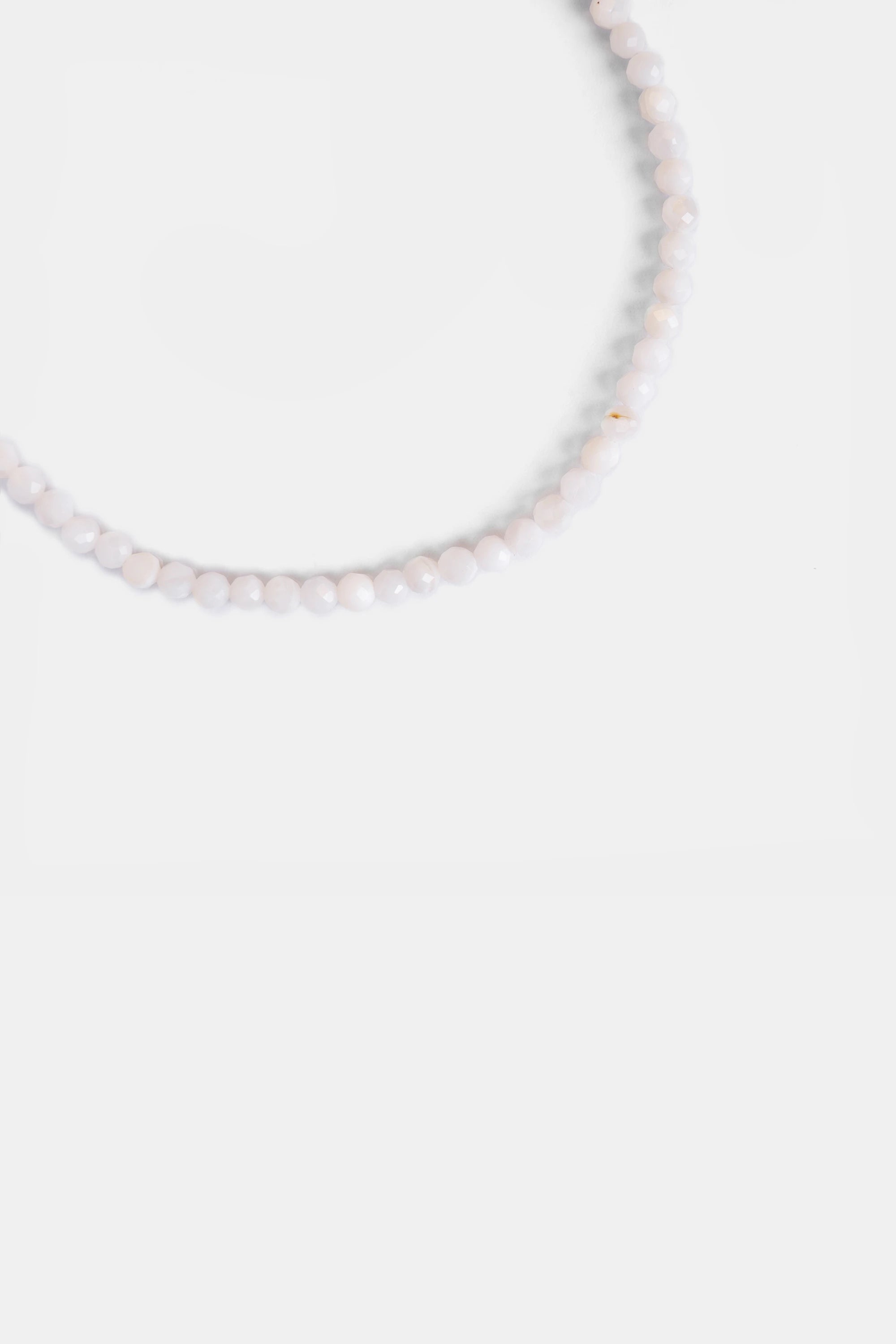 close-up of faceted white agate milky beads