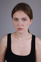 Model wearing clear crystal pendant necklace – minimalist gold choker