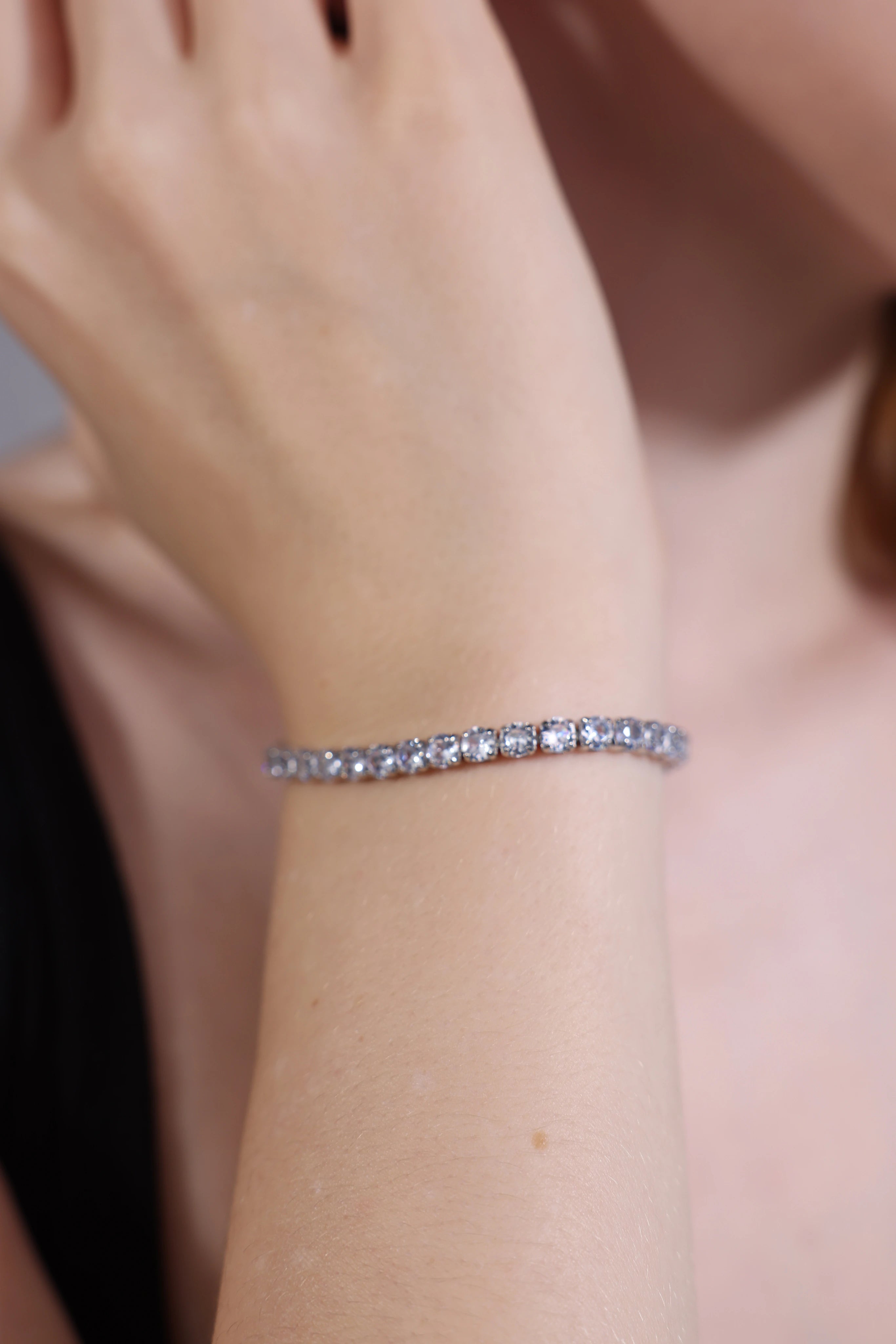 dainty white crystal CZ tennis bracelet on wrist – everyday jewelry