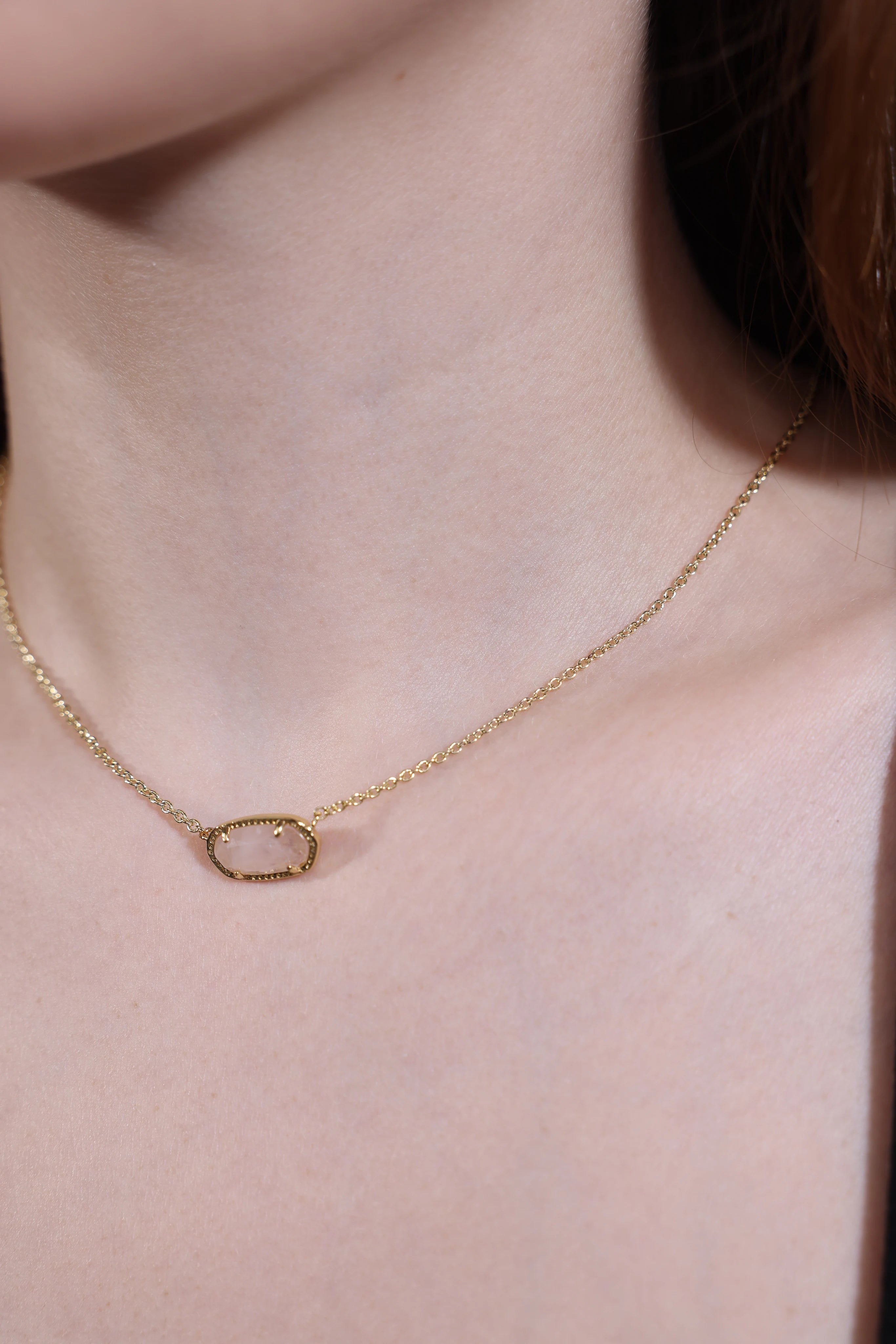 side view of rose quartz pendant necklace with gold chain