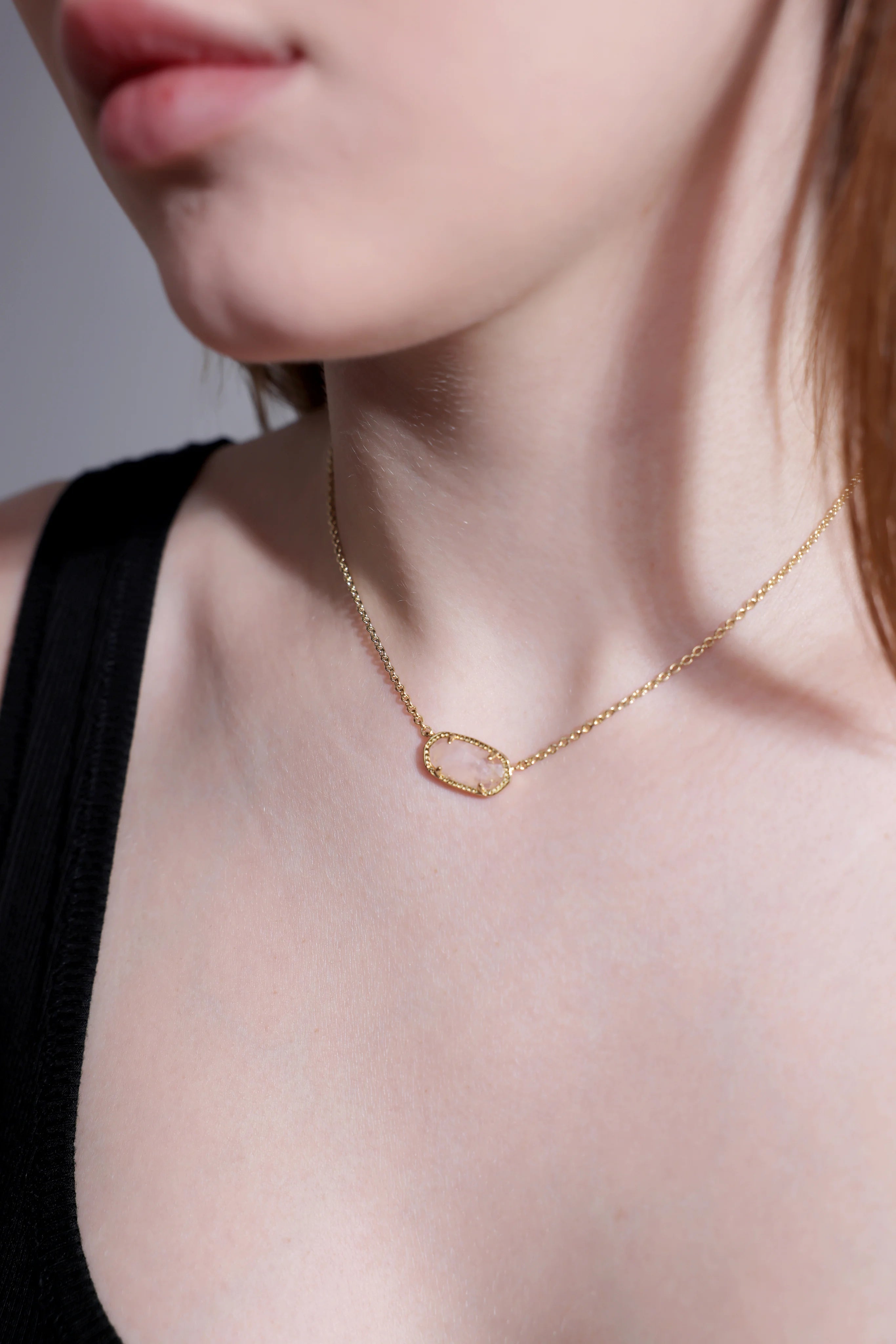 Model wearing rose quartz necklace pendant – minimalist gold choker